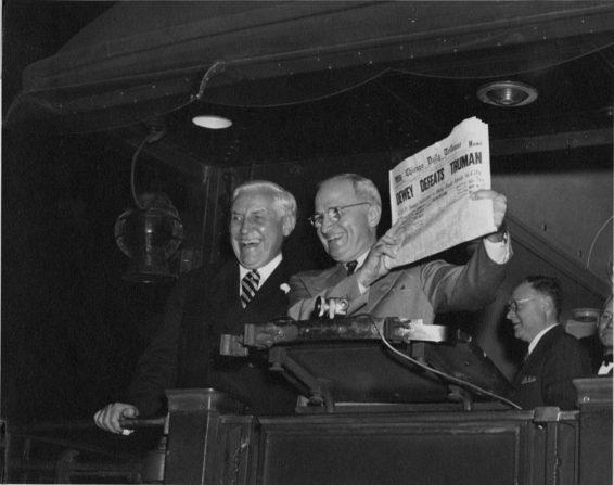 At St. Louis Union Station, postmaster Bernard Dickmann (left) stands next to newly elected President Harry S. Truman as Mr. Truman holds up the famous Chicago Tribune newspaper headline "Dewey Defeats Truman."