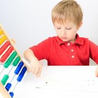 small boy playing math game